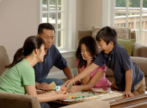 family playing board game in house